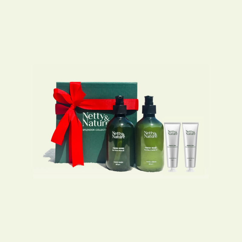 Netty & Nature gift set — deep-green box with a red ribbon, two pump bottles and two hand cream tubes