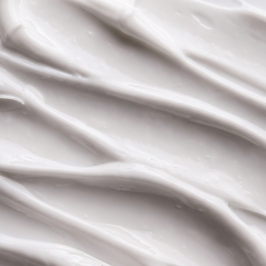 Close-up of rich, swirled white hand cream texture